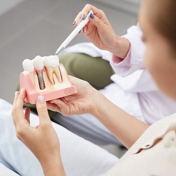 dentist explaining tooth implantation