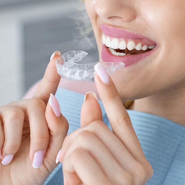 girl trying on invisible braces or trainer